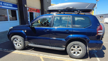 A Thule Motion XT Roof Box fitted to a Toyota Land Cruiser