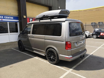 A Thule Motion XT Roof Box fitted to a VW Transporter