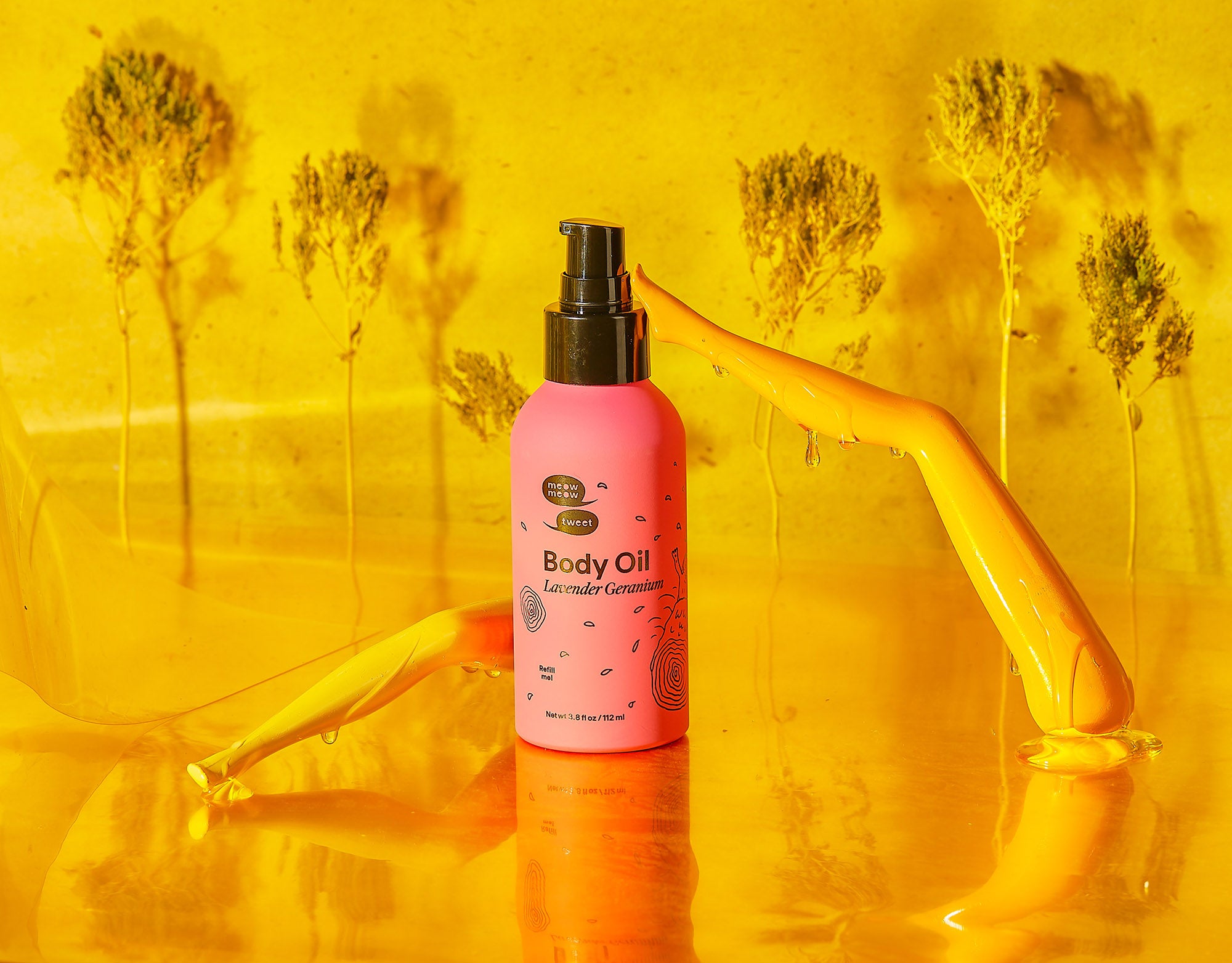 A pink bottle of body oil with two barbie legs on a golden yellow background