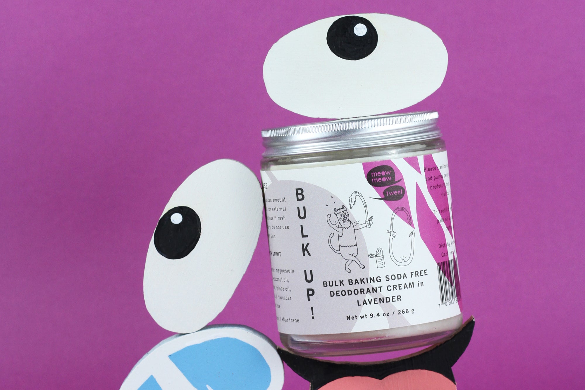 a bulk deodorant sitting with wooden carved and painted emojis of googley eyes