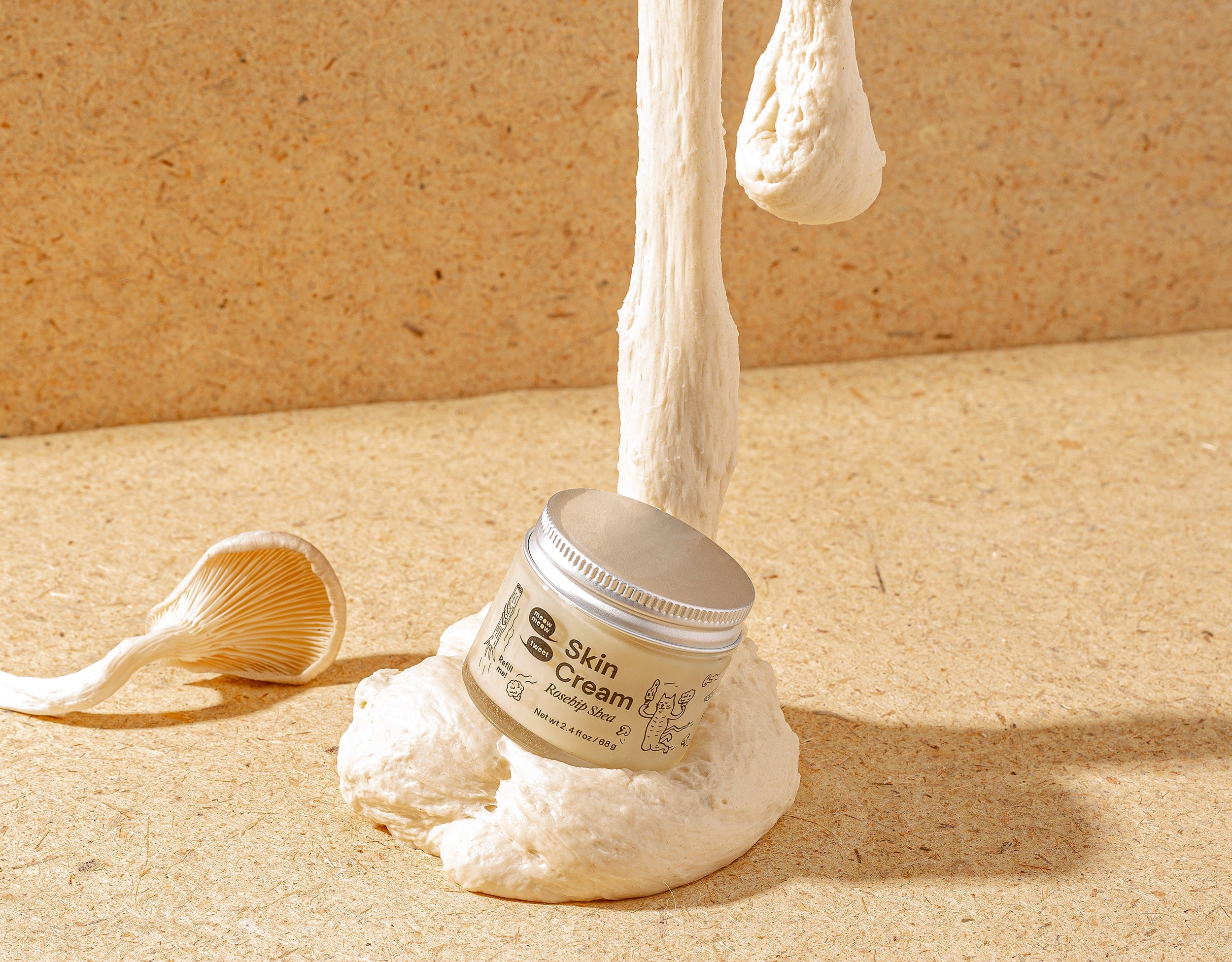 A skin cream sits on a pile of uncooked dough on a tan background