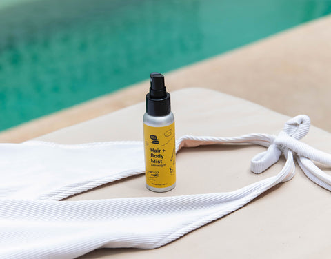 A yellow bottle sits poolside with a white bathing suit