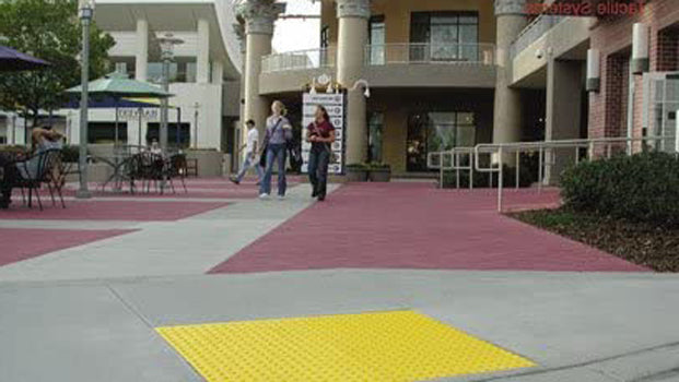 Truncated Domes on a sidewalk near a mall courtyard