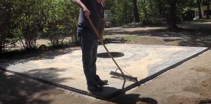 polymeric sand being swept into pavers