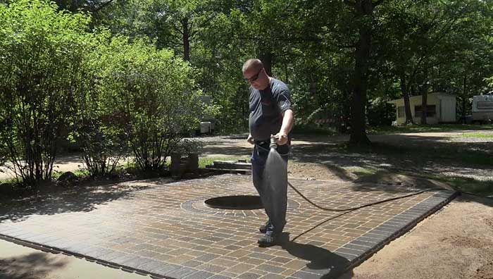 wetting polymeric sand in pavers