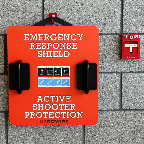 Active Shooter shield hung next to a fire alarm. Emergency tools for active shooter event.