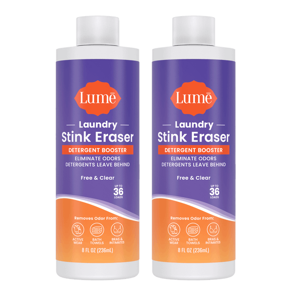 Two purple and orange bottles of Laundry Stink Eraser Detergent Booster with the text "Eliminate odors detergents leave behind. Up to thirty six loads." There are three icons indicating it removes odor from activewear, bath towels, and bras and intimates