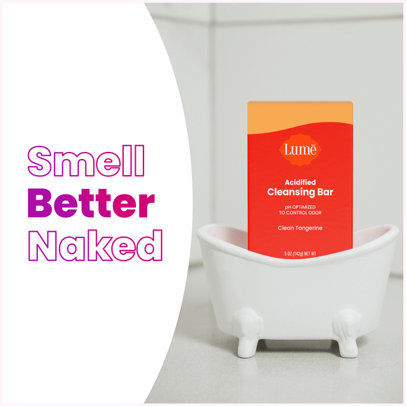 The text "smell better naked" alongside an acidified cleansing bar package in a tiny bathtub