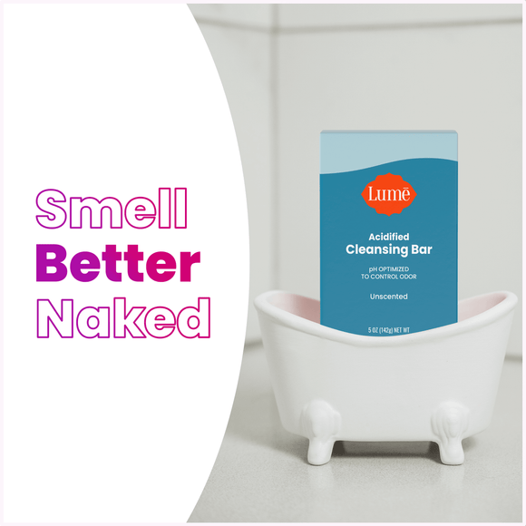 The text "smell better naked" alongside an acidified cleansing bar package in a tiny bathtub