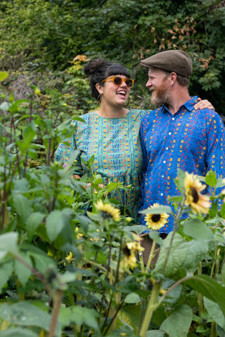Sarah and Rory together laughing in a field of sunflowers