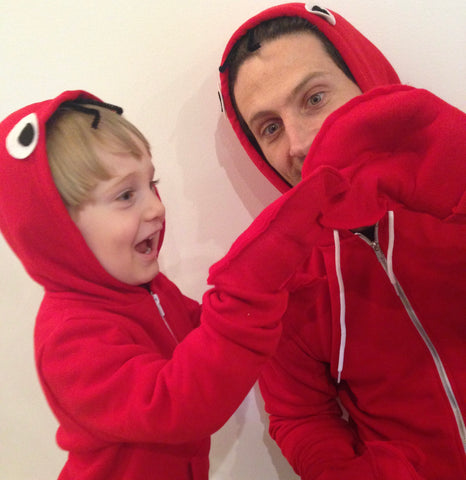 child and father in matching red hoodies