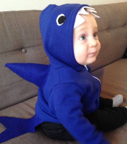 baby in a hoodie with a shark tail and fin