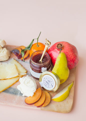 charcuterie board of cheese, jam, and fruit