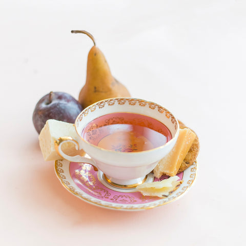 tea cup with cheese and fruit