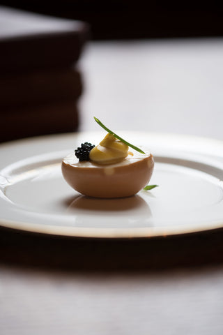 deviled egg with caviar on white plate