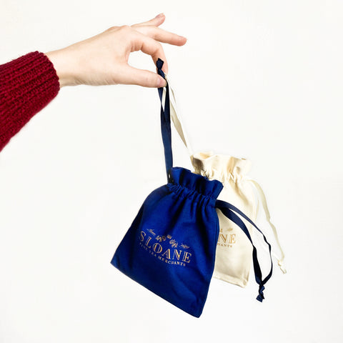 hand holding sloane suede pouches