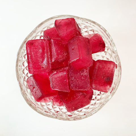 glass bowl of crimson berry tea ice cubes