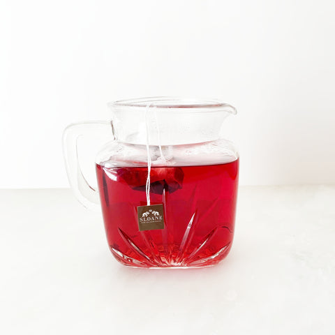 glass pitcher of fully infused crimson berry tea