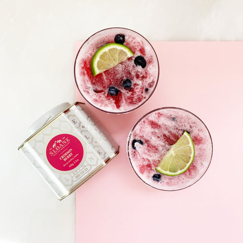 frozen crimson berry in glasses with lime and blueberries