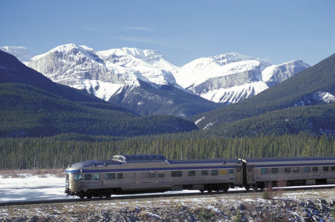 Via Rail train driving through mountain landscape