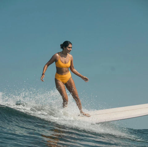 girl surfing in yellow bikini