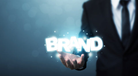 Person holding out hand with the word ‘BRAND’ above lit up