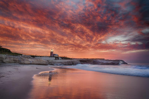 Santa Cruz Lighthouse, magnificent maroon sunrise on beach