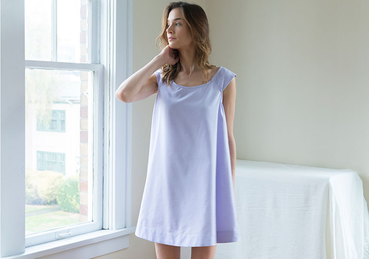 Model standing by window in Swing Nightie in Lilac Royal Oxford 