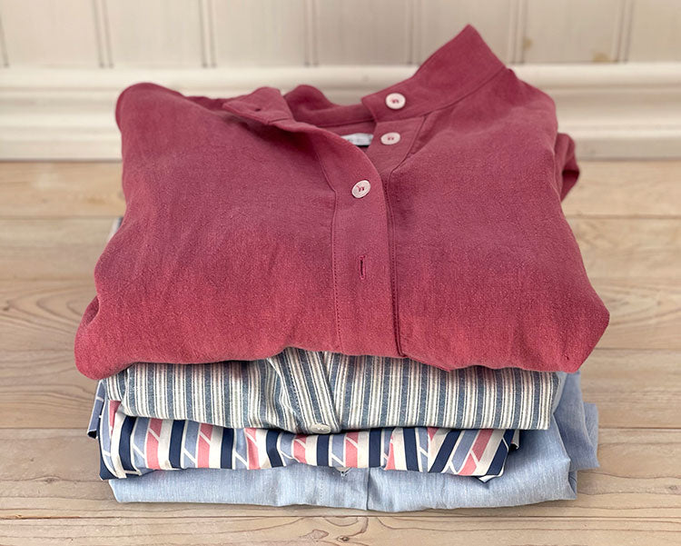 A stack of nightshirts in tones or pink and blue