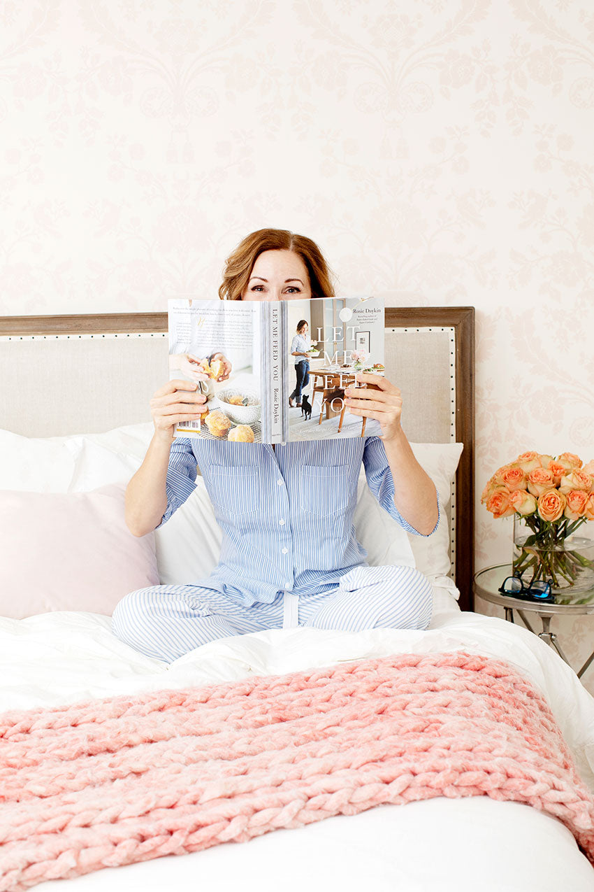 Rosie Daykin in bed with striped blue pajama set