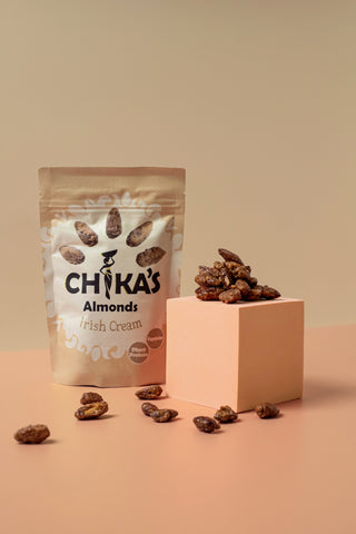 A close-up of CHIKA'S Irish Cream Almonds, highlighting the rich texture of the almonds coated in a velvety layer of Irish cream, promising a delightful snacking experience