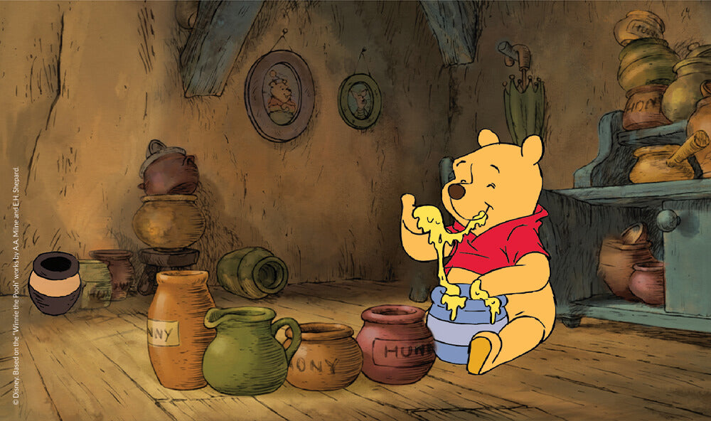 Winnie the Pooh eating honey.