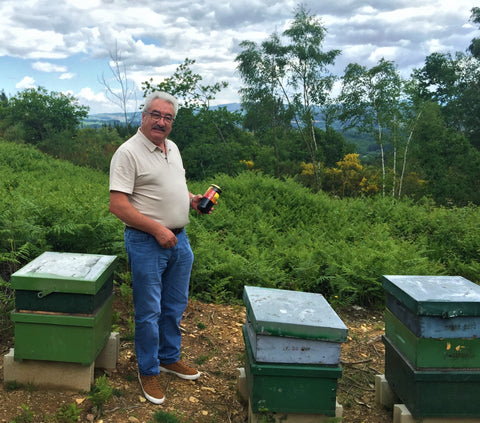 David Raw Honey Beekeeper with Hives and Honey