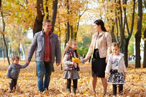 Family walking in the leaves