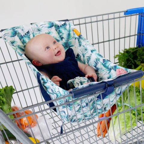 Baby in tropical leaf print shopping cart hammock