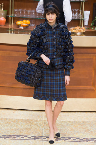 Woman walking the Chanel catwalk wearing blue Harris Tweed