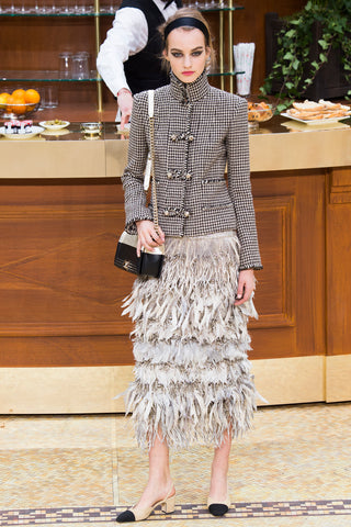 Woman walking on the Chanel catwalk wearing Harris Tweed