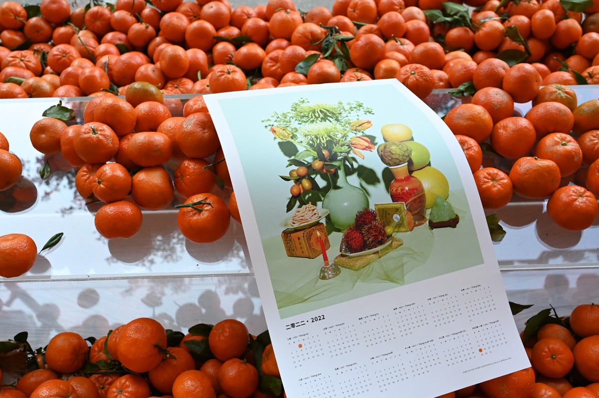Year of the Tiger Calendar draped over a pile of mandarins