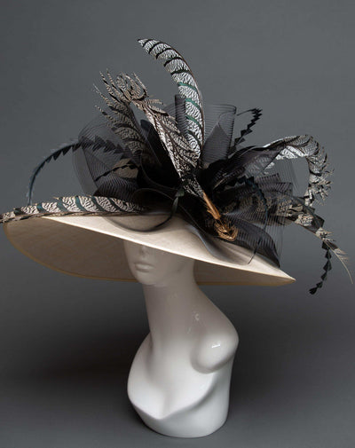 wide-brimmed ivory hat with zebra feathers