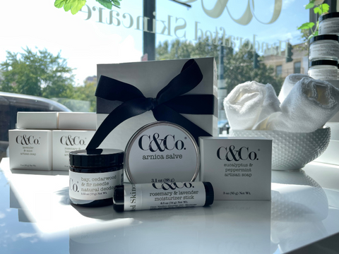 Four skincare products displayed against gift box