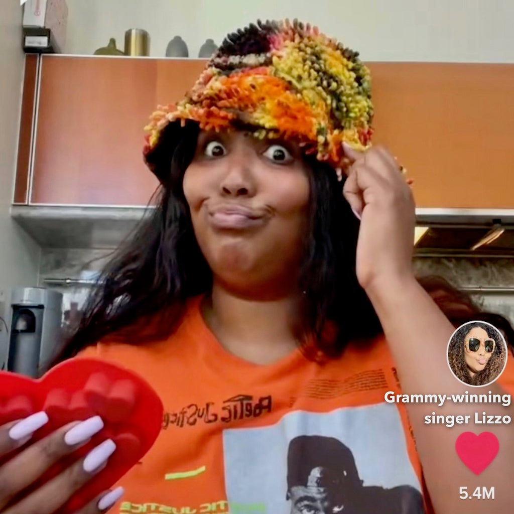 Grammy-winning singer Lizzo wearing a SHAG Bucket Hat by SHAGBAGG