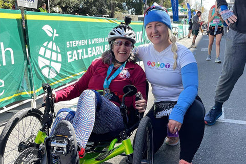 Andrea Peet, triker with ALS, and a friend, at a marathon on her Catrike Pocket.