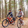 Bike to work week sales promo with 2 people riding bikes through the Stevens Point green circle bike trail