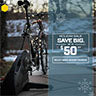 A bike lit up with holiday lights is on a Saris trainer and the slide announce the $50 off sale.