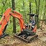 Heavy equipment forms mountain bike riding trail features at Standing Rocks County Park.