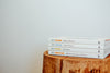 Close-up pile of books on wooden log