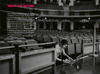 Portrait of author Gavin Strange in an auditorium on his laptop