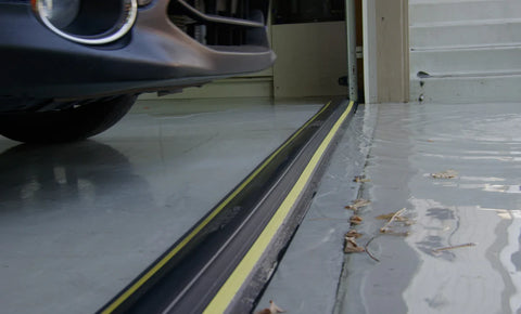 Floor mounted garage door threshold eliminates gaps underneath the door