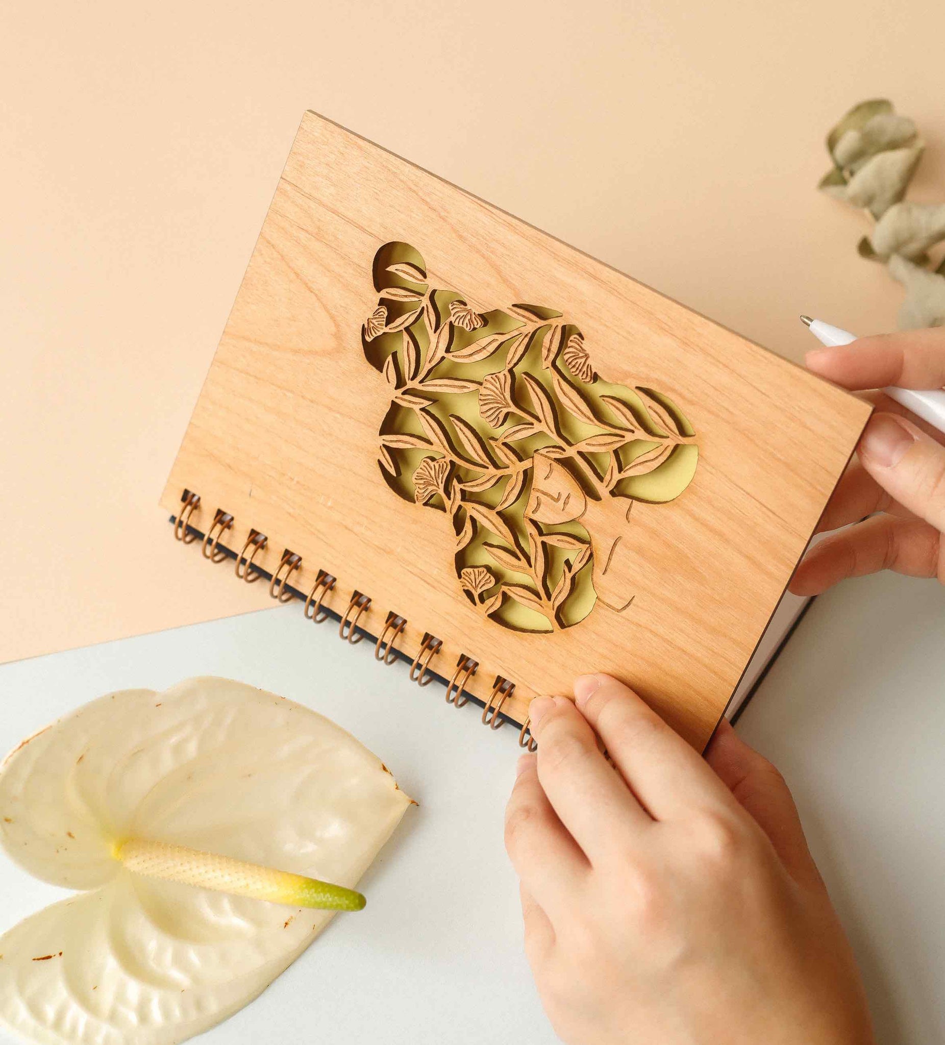 wooden journal with laser-cut botanical design