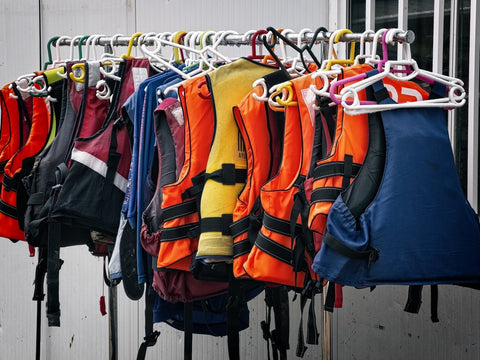 safety vests on a clothes rack